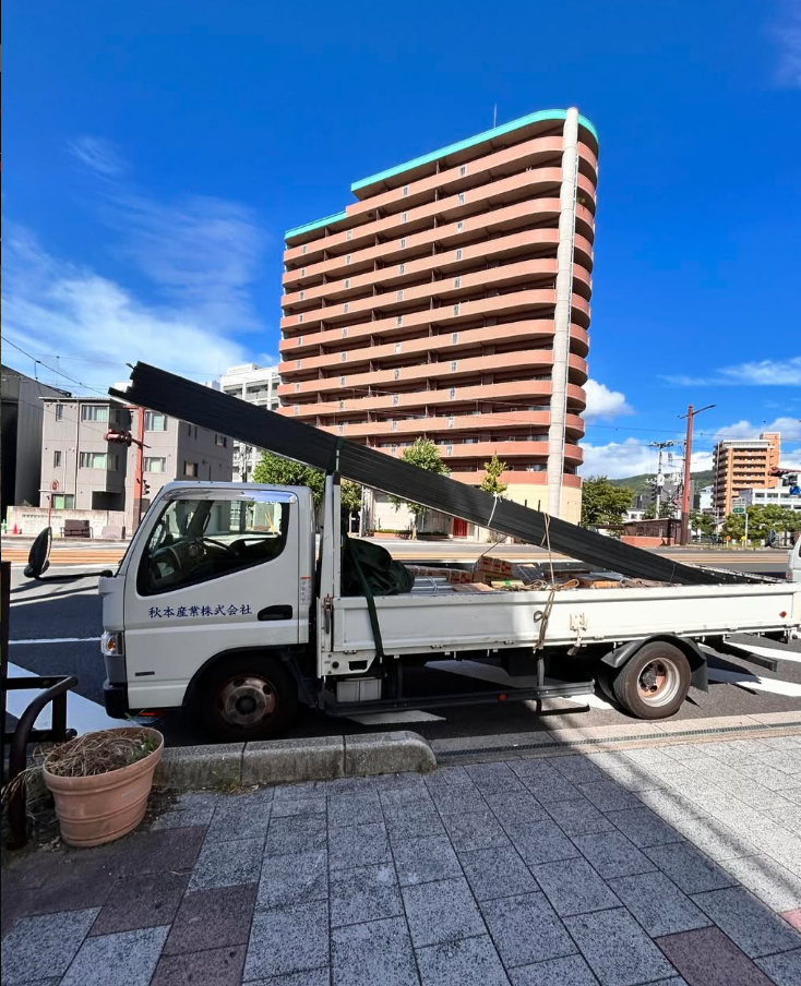 秋本産業のクレーン付き配送車。資材を積んで現場へ向かう